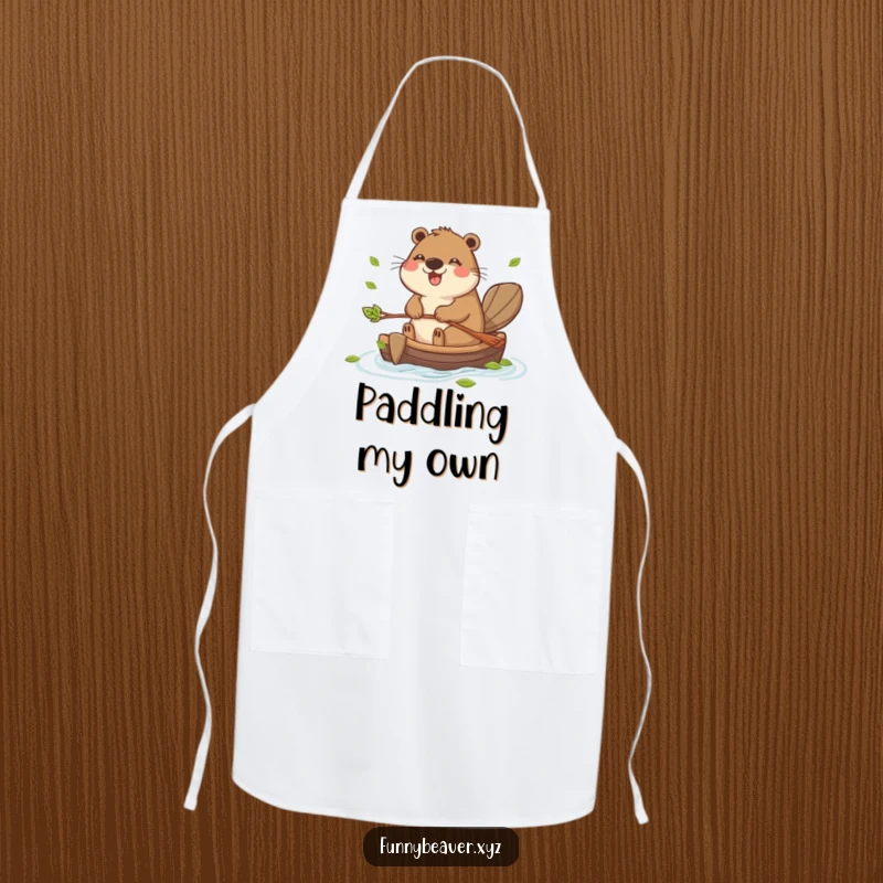 Funny apron with a joyful beaver paddling a small raft made of leaves, ideal for adding humor to any cooking or crafting session.